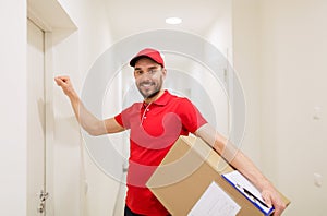 Delivery man with parcel box knocking on door