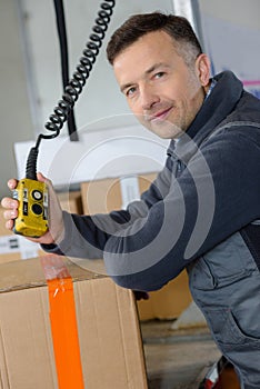 Delivery man with parcel near cargo truck shipping service