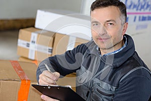 delivery man with parcel near cargo truck shipping service