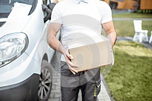 Delivery man with parcel outdoors