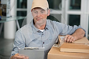 delivery man with parcels and clipboard