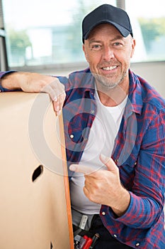 Delivery man pointing cardbox