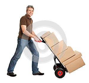 Delivery man pushing hand truck and stack of boxes