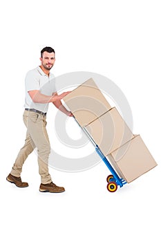 Delivery man pushing trolley of boxes