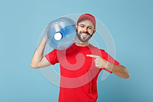 Delivery man in red uniform cap t-shirt print workwear carrying bottle of water to office cooler isolated on blue