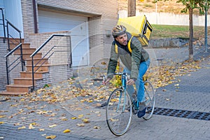 Delivery man riding bike delivering food and drink in town outdoors on stylish bicycle and backpack.