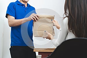 Delivery Man sending package to receiver on doorway