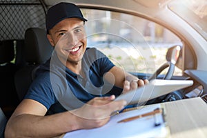 Delivery man sitting in a delivery van