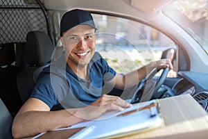 Delivery man sitting in a delivery van