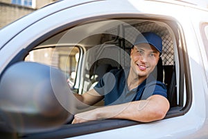 Delivery man sitting in a delivery van