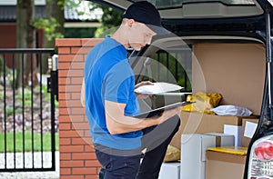 Delivery man taking package from car