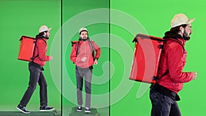 Delivery man with thermal backpack running on a Green Screen, Chroma Key.