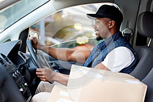 Delivery man, transport and man driving with a smile for shipping or courier service. Happy black person or driver with