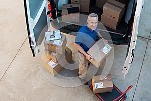 Delivery man unloading parcel