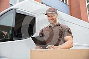 Delivery Man Using Digital Tablet