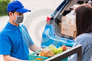 Delivery man wear face mask grocery fast service giving fresh food vegetable to woman customer