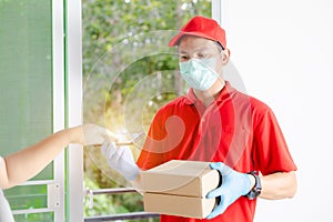 A delivery man wearing a red dress holds a parcel box