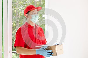 A delivery man wearing a red dress holds a parcel box