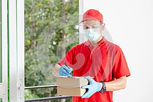 A delivery man wearing a red dress holds a parcel box