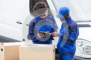 Delivery Man Writing On The Clipboard