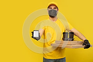 Delivery man in yellow t-shirt, mask, gloves isolated. Guy hold takeaway cup of coffee. Coronavirus 2019-ncov concept