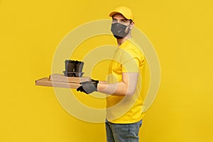 Delivery man in yellow t-shirt, mask, gloves isolated. Guy hold takeaway cup of coffee. Coronavirus 2019-ncov concept