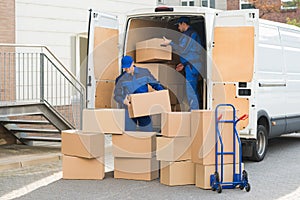 Delivery Men Unloading Boxes On Street