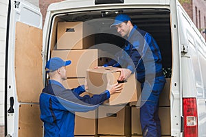 Delivery Men Unloading Boxes From Truck