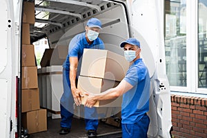 Delivery Men Unloading Cardboard Boxes