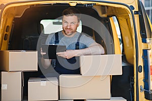 Delivery men unloading moving boxes from car