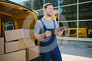 Delivery men unloading moving boxes from car