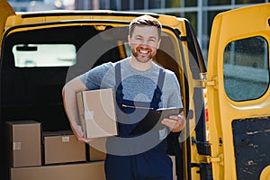 Delivery men unloading moving boxes from car