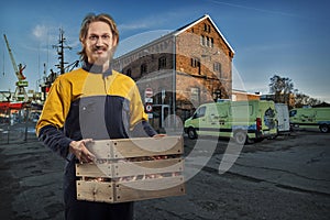 Delivery or mover man with box in the port
