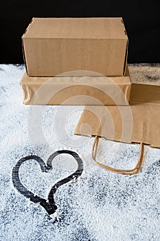 Delivery packing bag box craft pack flour meal heart table black background