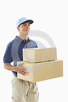 Delivery person carrying cardboard boxes
