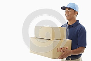 Delivery person carrying cardboard boxes