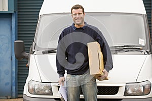 Delivery person standing with parcel