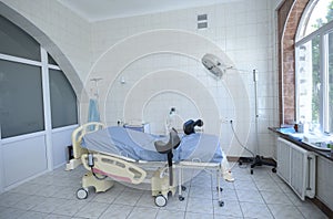 Delivery room of a maternity hospital, obstetric bed, lamp, medical equipment set photo