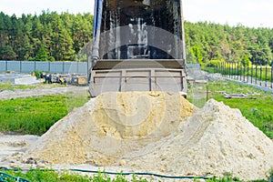 Delivery of sand for construction. dump truck unloads the sand. Place for your text