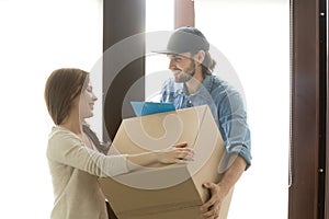 Delivery service concept, woman receiving box from courier at ho