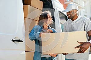 Delivery Service. Courier Delivering Package To Woman Near Car