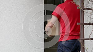 Delivery service courier ringing the house doorbell