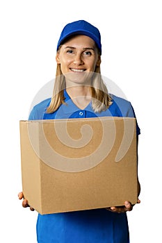 delivery service - happy deliverywoman in blue uniform holding cardboard box. isolated on white background
