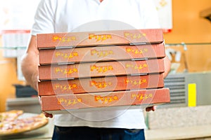 Delivery service - man holding pizza boxes