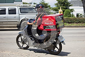 Delivery service man ride a Motercycle of Pizza Hut Company.