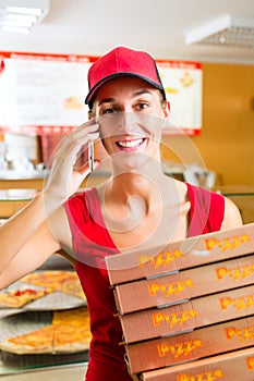 Delivery service - woman holding pizza boxes