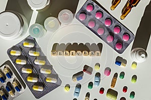 Delivery text surrounded by pills, blisters, medicine bottles.