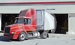 Delivery truck backing into warehouse bay