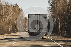 Delivery truck driving on a highway. car moving on a roadway