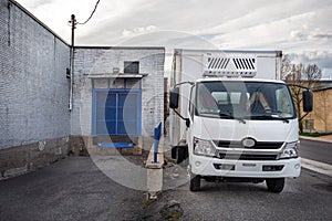 Delivery van in front of a small business building